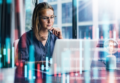 Pensive lady looking at her laptop screen against an imaginary background of statistical bar charts